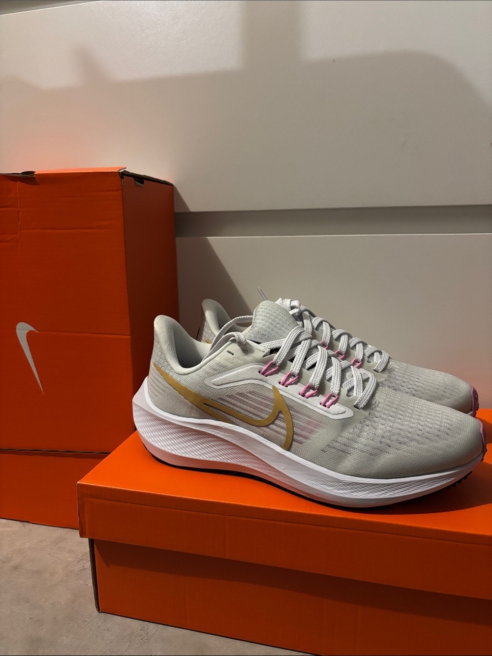 Nike Women’s Running Sneakers in Light Gray with Gold and Pink Accents